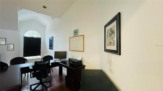 home office featuring lofted ceiling and dark hardwood / wood-style flooring