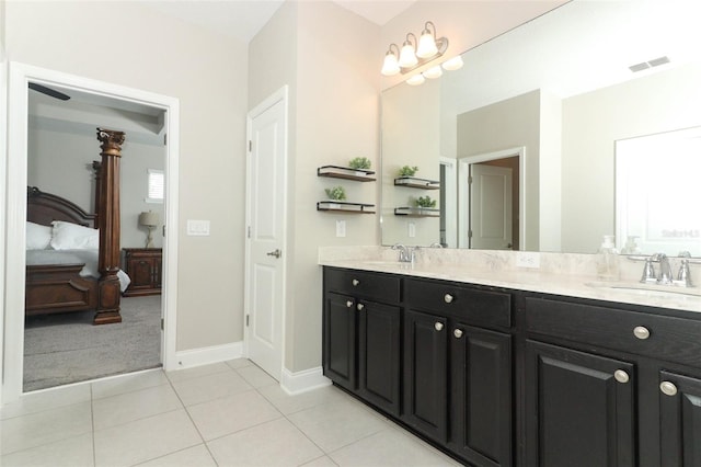 ensuite bathroom with double vanity, ensuite bath, visible vents, and a sink