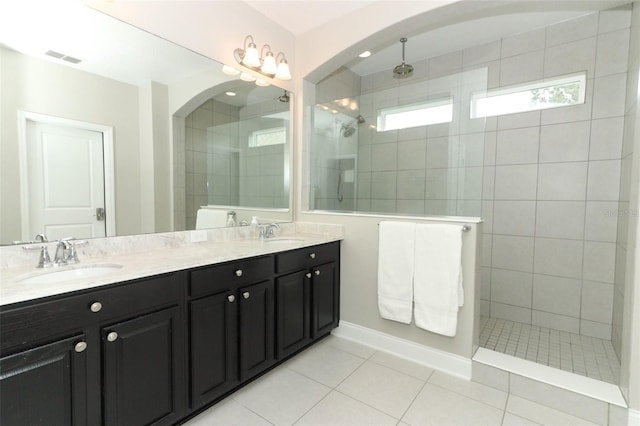 full bath with double vanity, visible vents, a walk in shower, and a sink