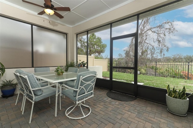 sunroom / solarium with a ceiling fan