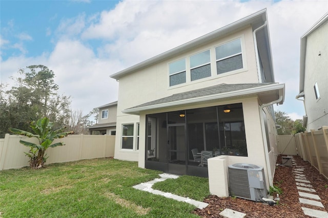 rear view of property with cooling unit, a sunroom, a fenced backyard, and a yard