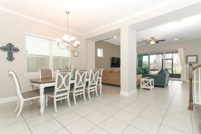 dining space featuring baseboards, ornamental molding, and light tile patterned flooring