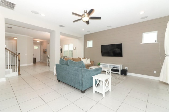 living room with visible vents, stairway, baseboards, and light tile patterned floors