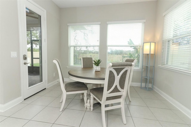 dining area with light tile patterned floors and baseboards