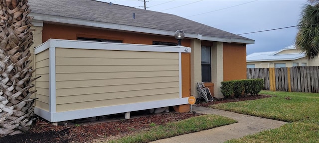 view of side of home featuring a lawn