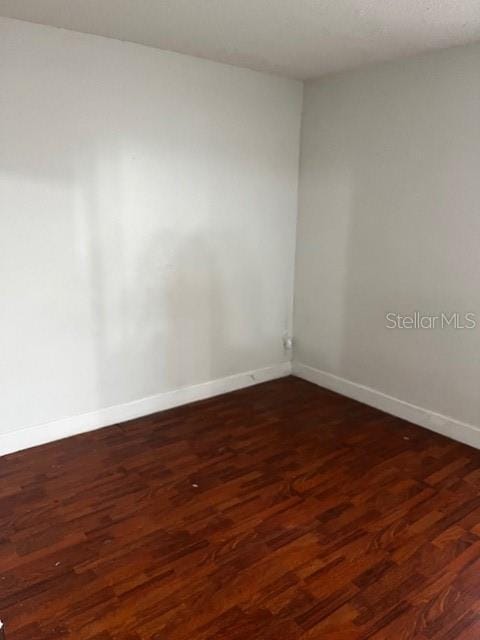 empty room featuring dark hardwood / wood-style floors