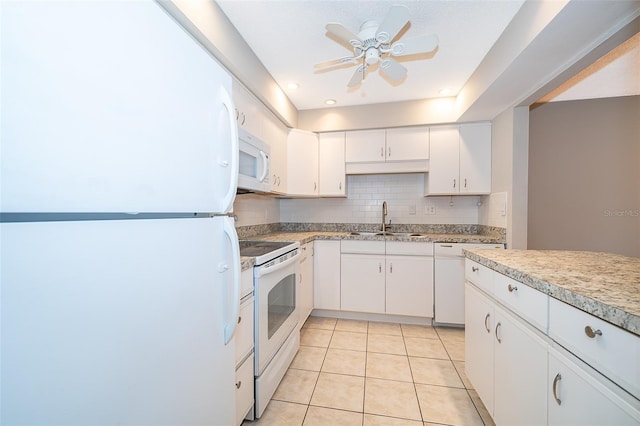 kitchen featuring white appliances, light tile patterned floors, ceiling fan, sink, and white cabinetry