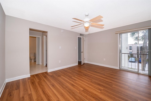 empty room featuring hardwood / wood-style flooring and ceiling fan