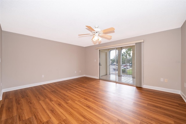 empty room with ceiling fan and hardwood / wood-style floors