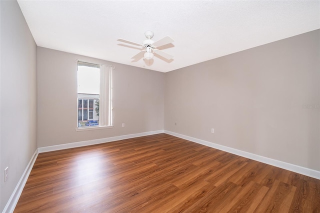 empty room with ceiling fan and wood-type flooring