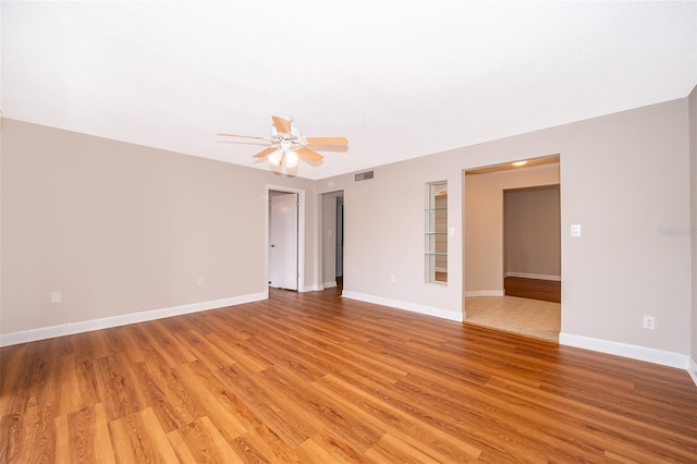 unfurnished room with ceiling fan and light hardwood / wood-style floors