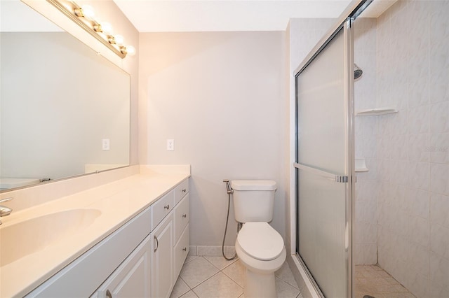 bathroom featuring toilet, tile patterned flooring, vanity, and a shower with shower door