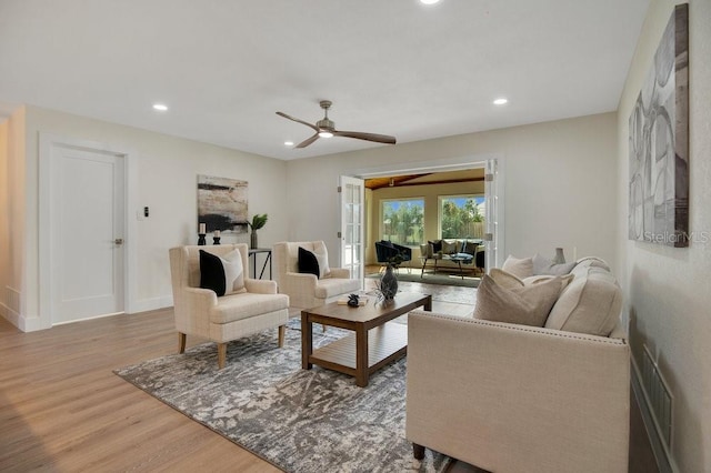 living room featuring light hardwood / wood-style floors and ceiling fan