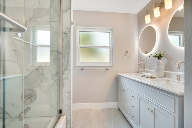 bathroom with bath / shower combo with glass door and vanity