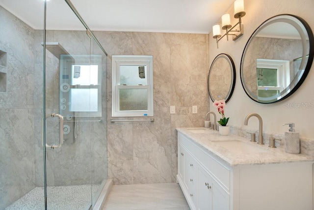 bathroom with tile walls, a shower with door, and vanity