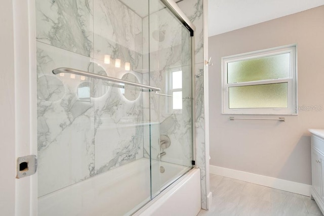 bathroom featuring enclosed tub / shower combo and vanity