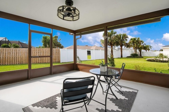 sunroom / solarium with ceiling fan and plenty of natural light