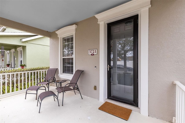 doorway to property with a porch