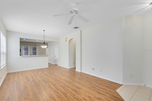 unfurnished living room with ceiling fan and light hardwood / wood-style floors