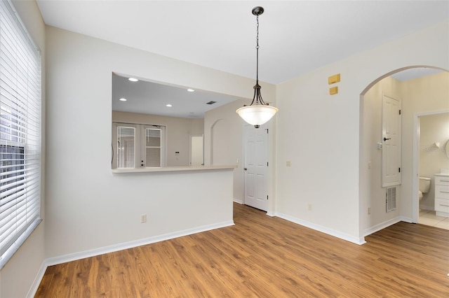 spare room featuring light hardwood / wood-style floors and plenty of natural light