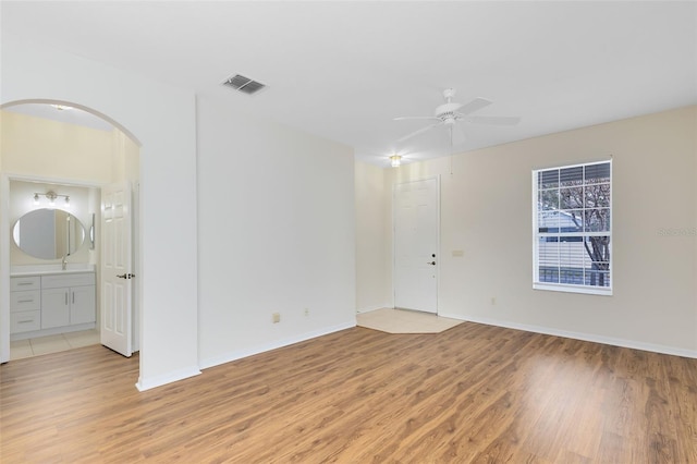 spare room featuring light hardwood / wood-style floors and ceiling fan