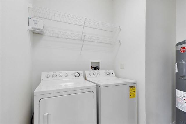 laundry area with water heater and washing machine and clothes dryer