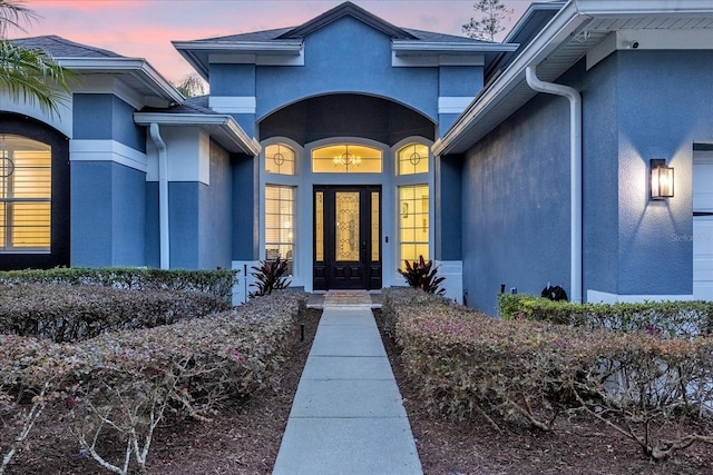 view of exterior entry at dusk