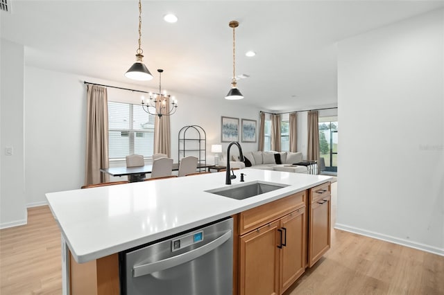 kitchen featuring a wealth of natural light, dishwasher, light hardwood / wood-style flooring, sink, and a center island with sink