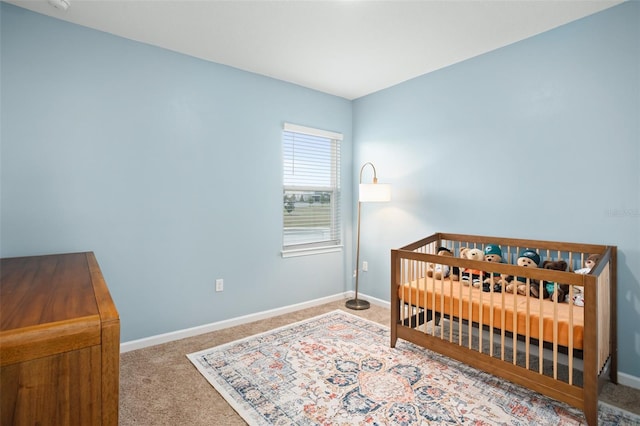 bedroom featuring carpet floors and a crib