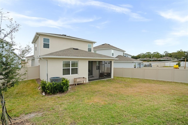 back of property featuring a sunroom and a yard