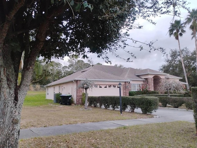 view of home's exterior with a lawn and a garage