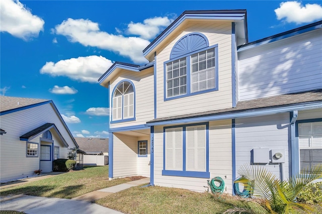 rear view of property featuring a yard