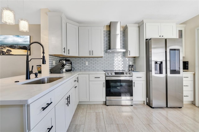 kitchen with wall chimney exhaust hood, pendant lighting, backsplash, appliances with stainless steel finishes, and sink