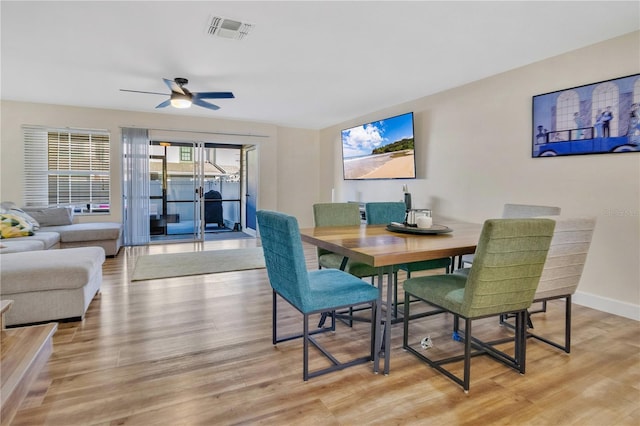 dining area with ceiling fan and light wood-type flooring