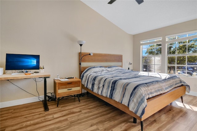 bedroom featuring wood-type flooring, ceiling fan, and vaulted ceiling