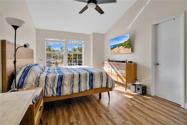 bedroom featuring ceiling fan, vaulted ceiling, and hardwood / wood-style flooring