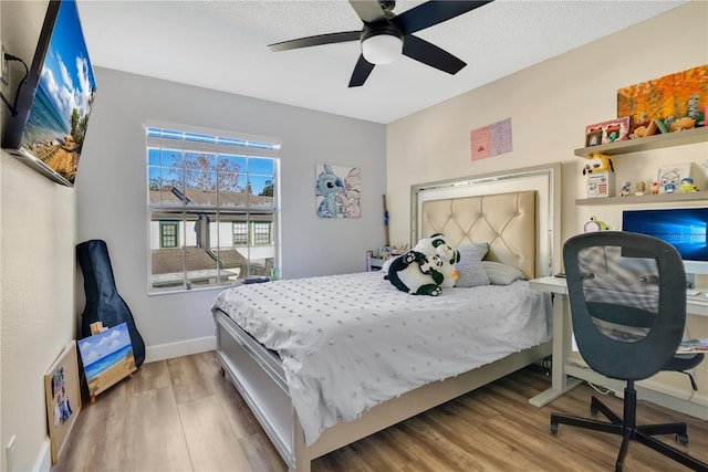 bedroom featuring light wood-type flooring and ceiling fan