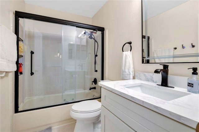 full bathroom featuring bath / shower combo with glass door, vanity, and toilet