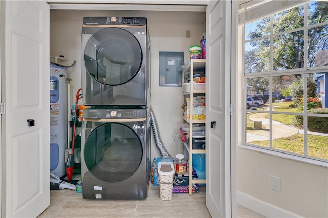 laundry room with electric panel, stacked washer / drying machine, and electric water heater