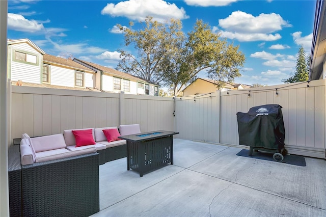 view of patio with an outdoor living space with a fire pit and area for grilling