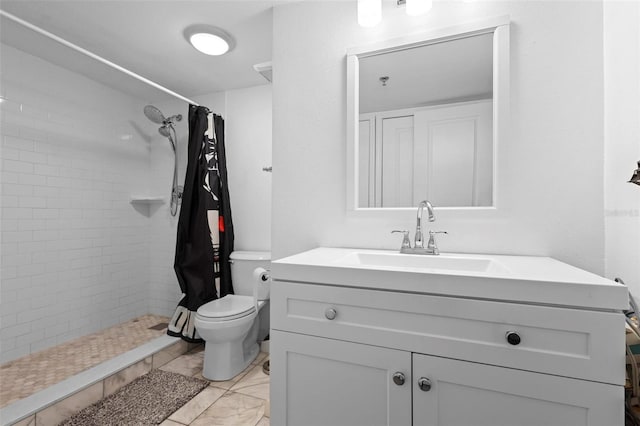 bathroom with a stall shower, vanity, and toilet