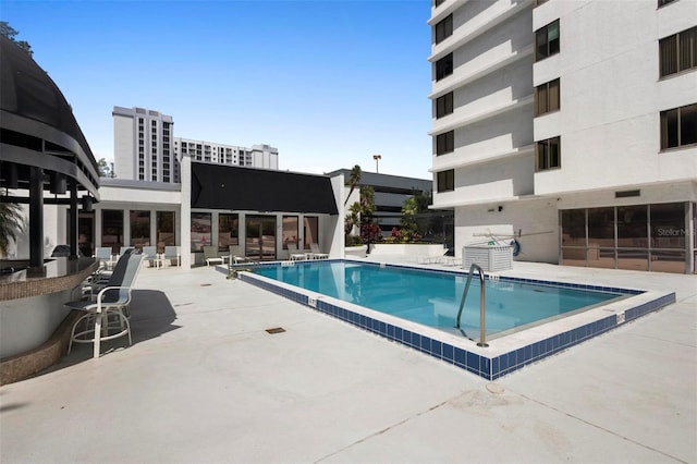 community pool with a patio area