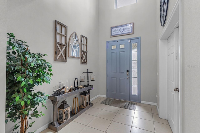 tiled entrance foyer featuring a high ceiling