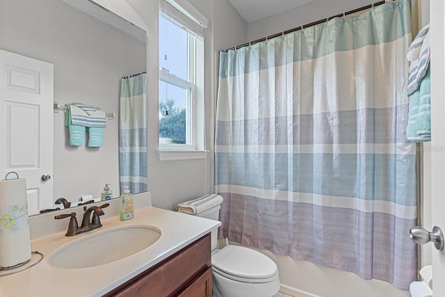 full bathroom featuring vanity, shower / bathtub combination with curtain, and toilet