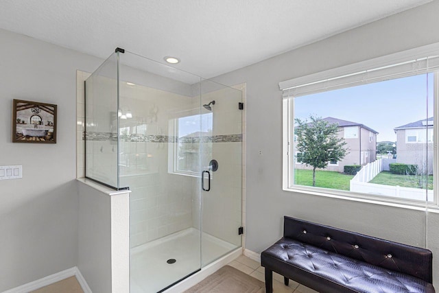 bathroom with tile patterned floors and walk in shower