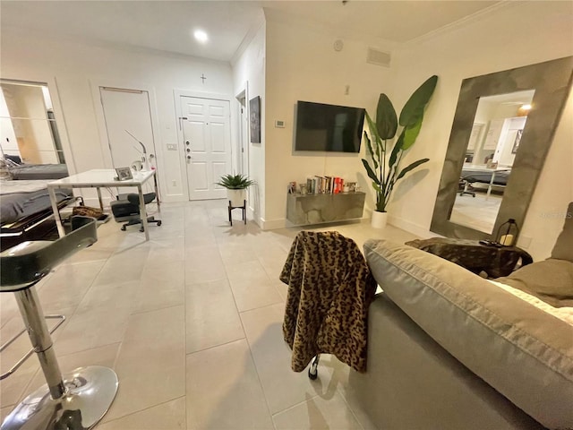 living room featuring tile patterned floors, baseboards, and crown molding