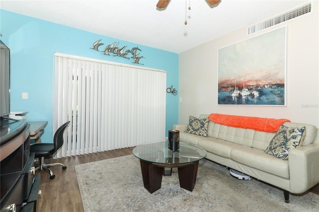 home office with hardwood / wood-style flooring and ceiling fan