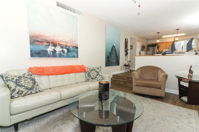 living room with hardwood / wood-style flooring and a textured ceiling