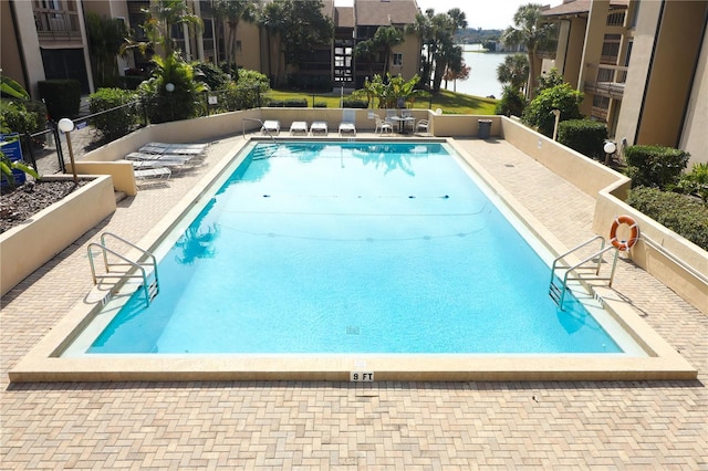 view of pool with a water view