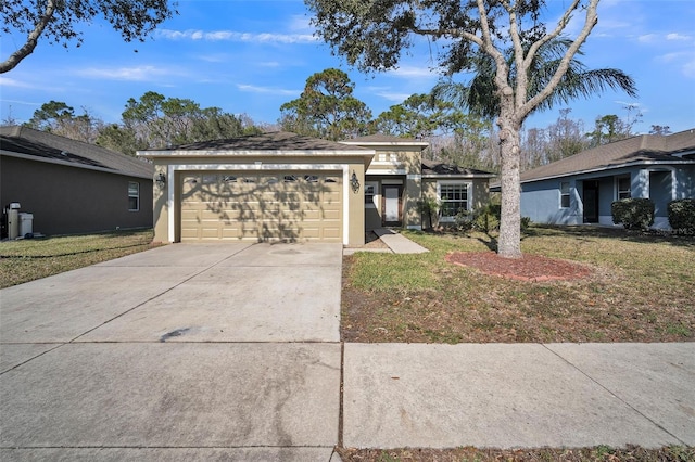 ranch-style home featuring a garage and a front lawn